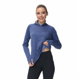 Femme portant un pull fin bleu sur fond blanc.